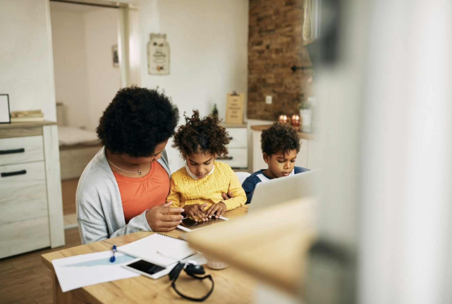 A mother helping her kids with homework