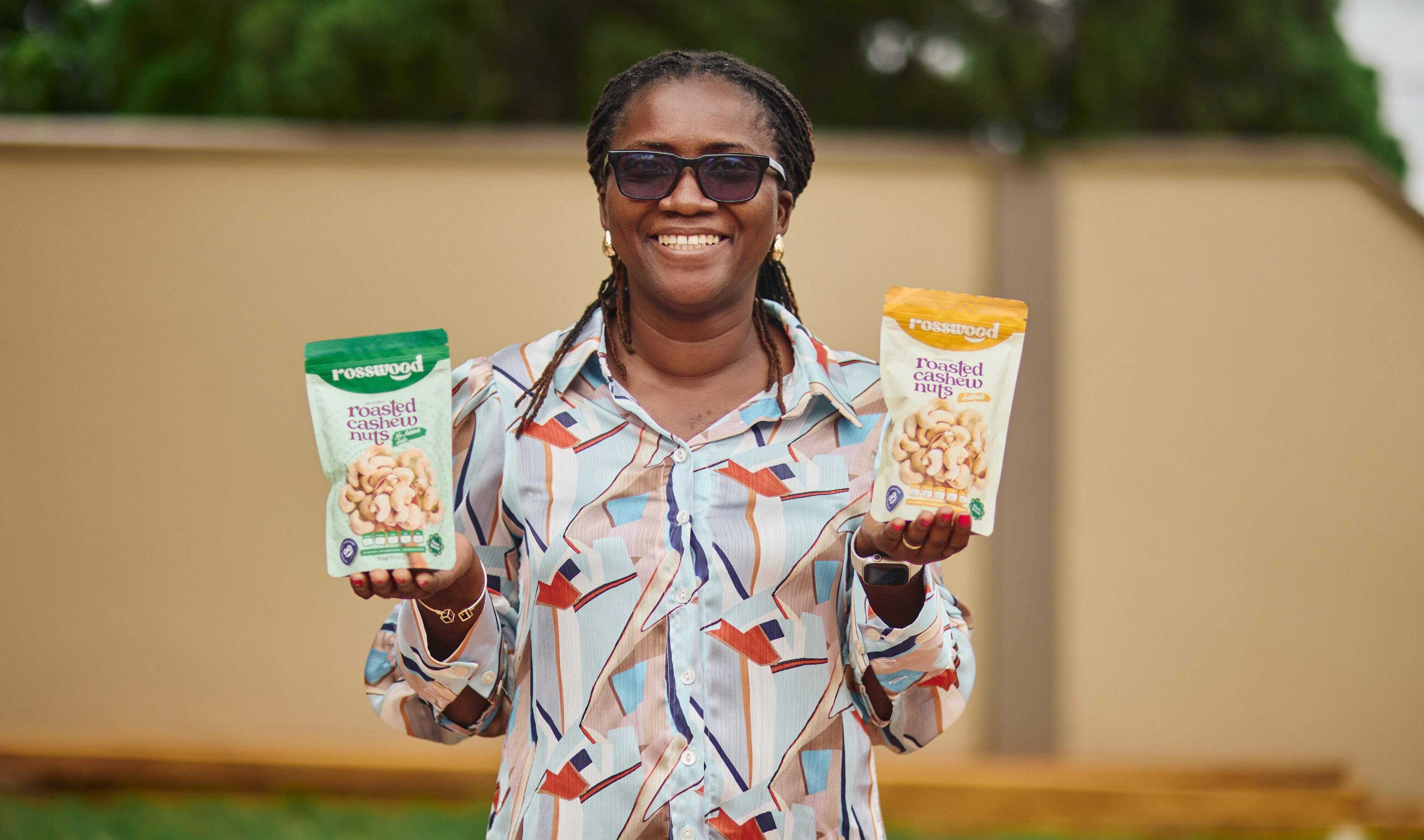 Priscilla Asanta, founder of Rosswood, holding her cashew products.