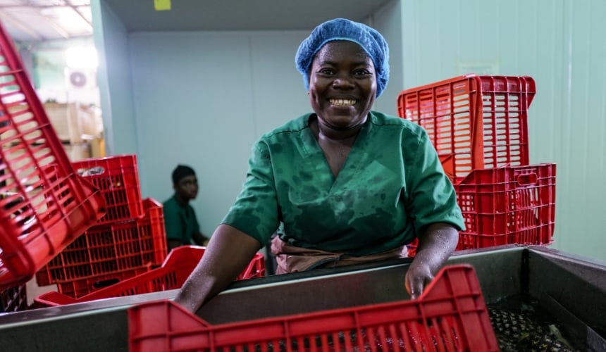 An employee of Pure and Just Food smiling.