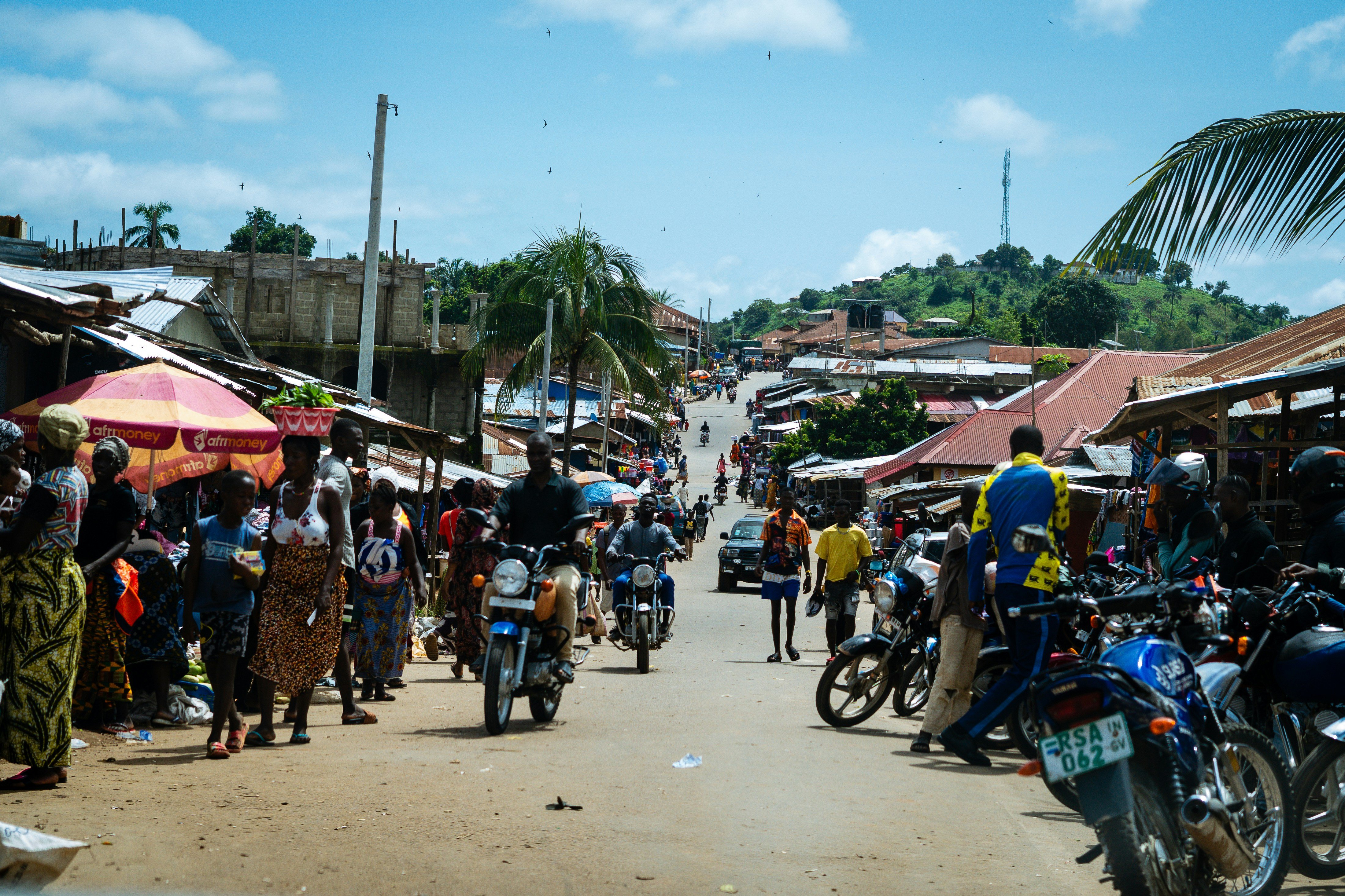 Motorbikes at a busy marketplace in Sierra Leone
